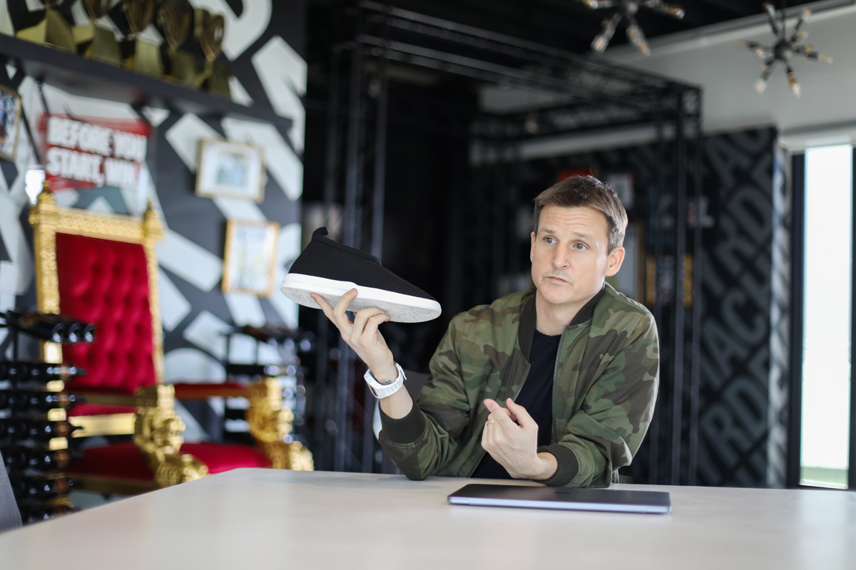 Rob Dyrdek holds a Lusso Cloud slipper at Dyrdek Machine headquarters