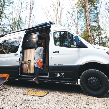A person stepping into the Airstream Interstate 24X adventure van