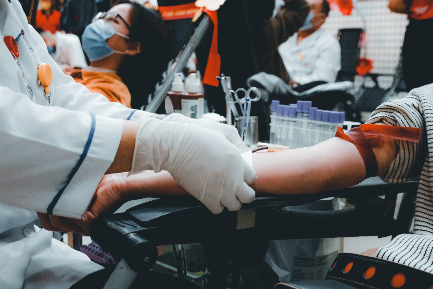 Photo shows doctor taking blood from patient