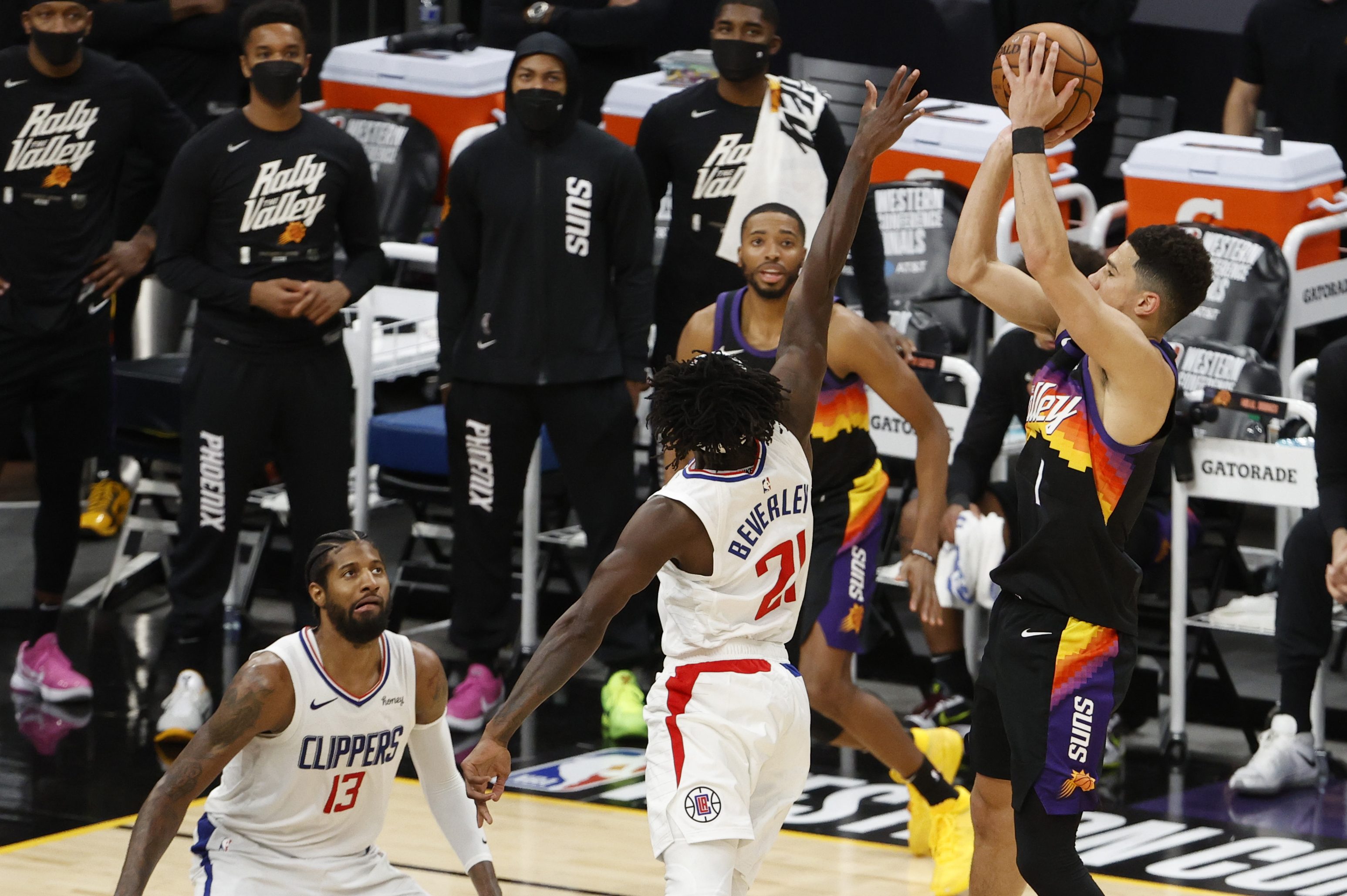 Devin Booker shoots over Patrick Beverley