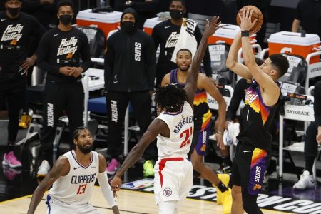 Devin Booker shoots over Patrick Beverley