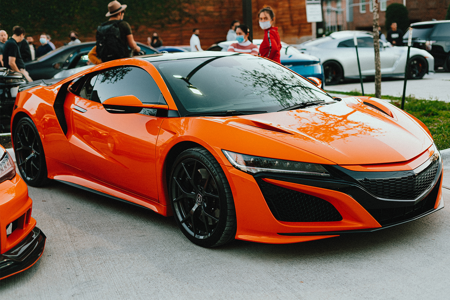 An orange Acura NSX at a car show in Houston, Texas