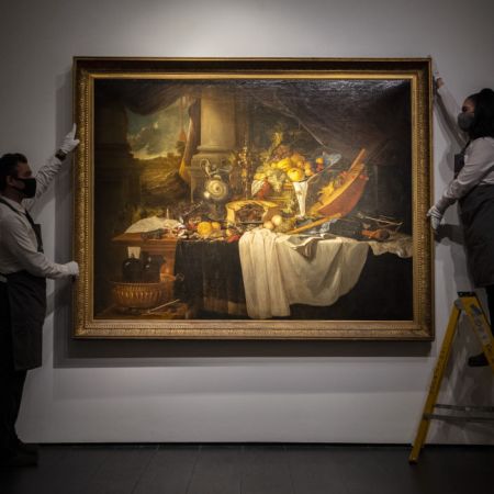 "A banquet still life" by Jan Davidsz De Heem being hung on a wall
