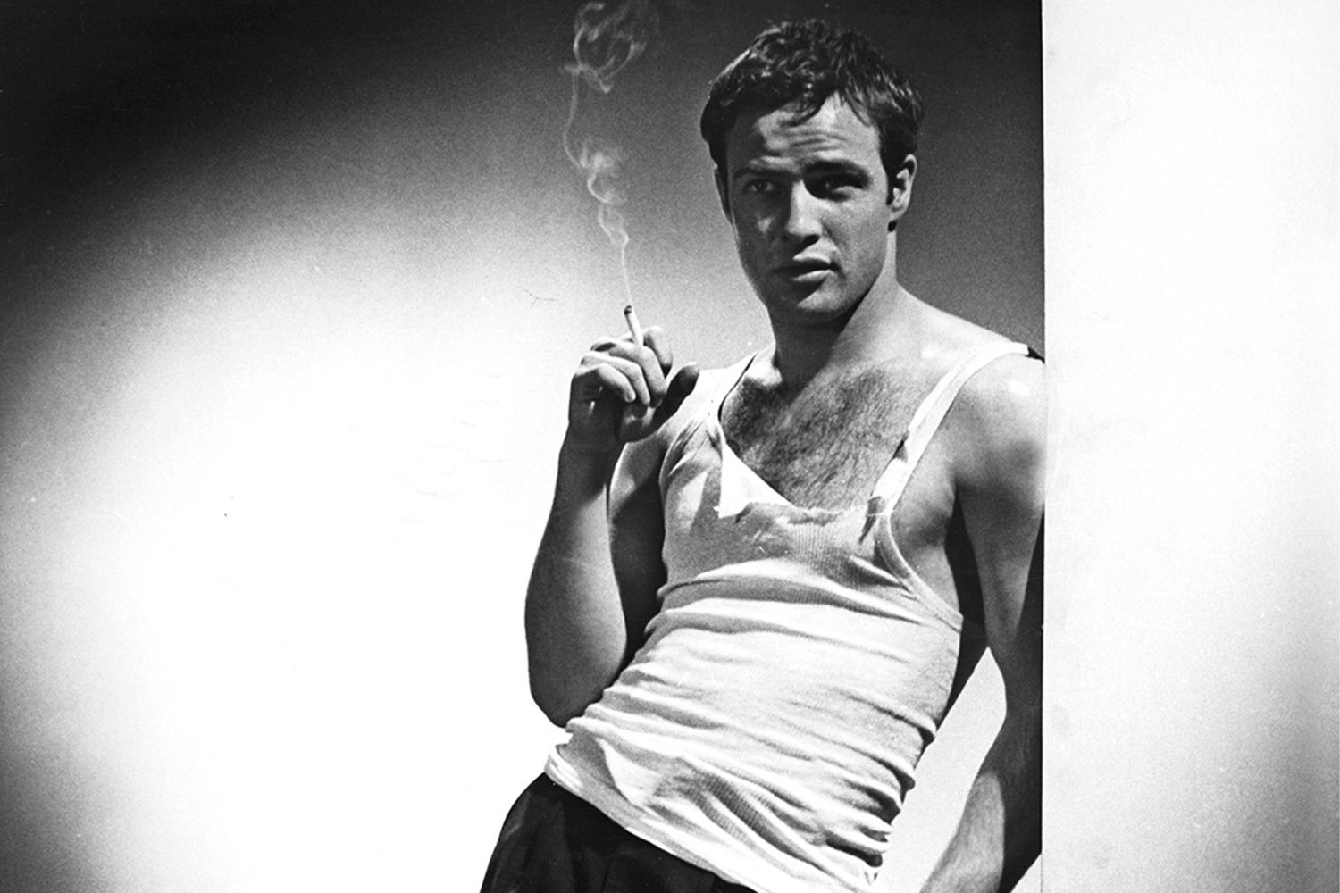 a photo of Chris Pine wearing a white tank top