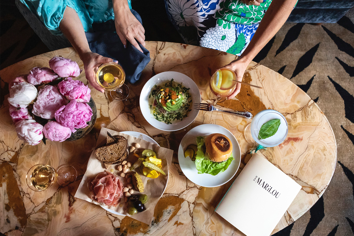 At Bar Marilou, diners can eat high-minded light bites like a Frisee salad, but there's also a burger