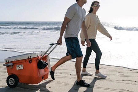 two models dragging a ROVR camping cooler behind them