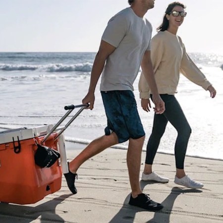 two models dragging a ROVR camping cooler behind them