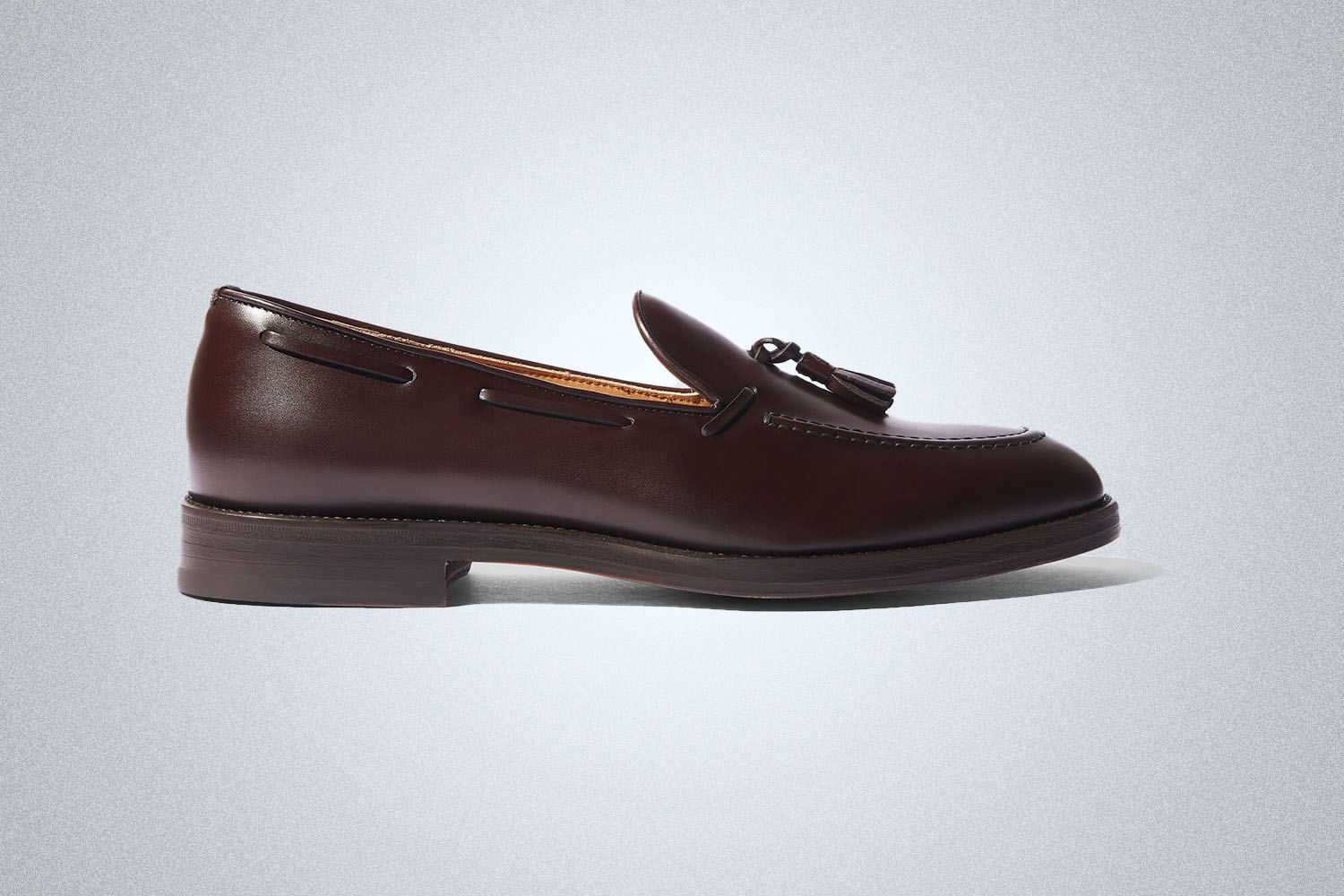 A pair of brown leather summer loafers from Scarosso on a grey background