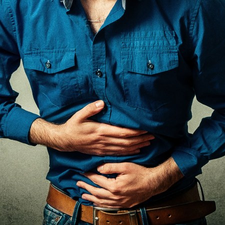 Men are reluctant to discuss gut health; that decision may be killing them. Pictured: A man clutching his stomach.