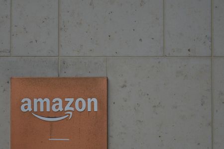 Amazon logo on the side of a building. A new investigation from The Wall Street Journal found some Amazon retailers contacted buyers about bad reviews.