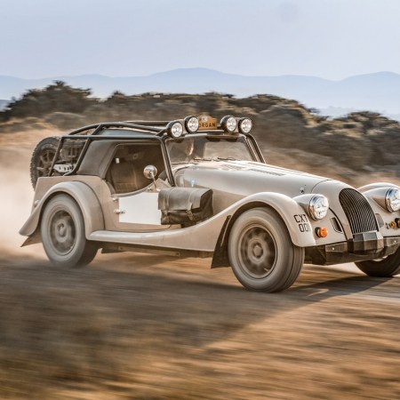 The new Morgan Plus Four CX-T driving on an off-road trail. The new limited-edition sports car from Morgan Motor Company was built in partnership with Rally Raid UK.