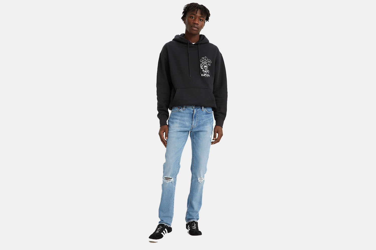 A model wearing Levi's 511 Slim-Fit light wash jeans.