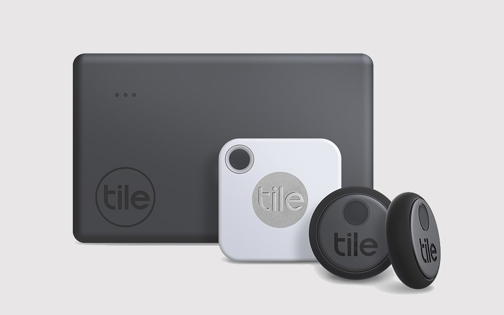Three different sizes of Tile's Bluetooth trackers, from large rectangular ones to small circular trackers