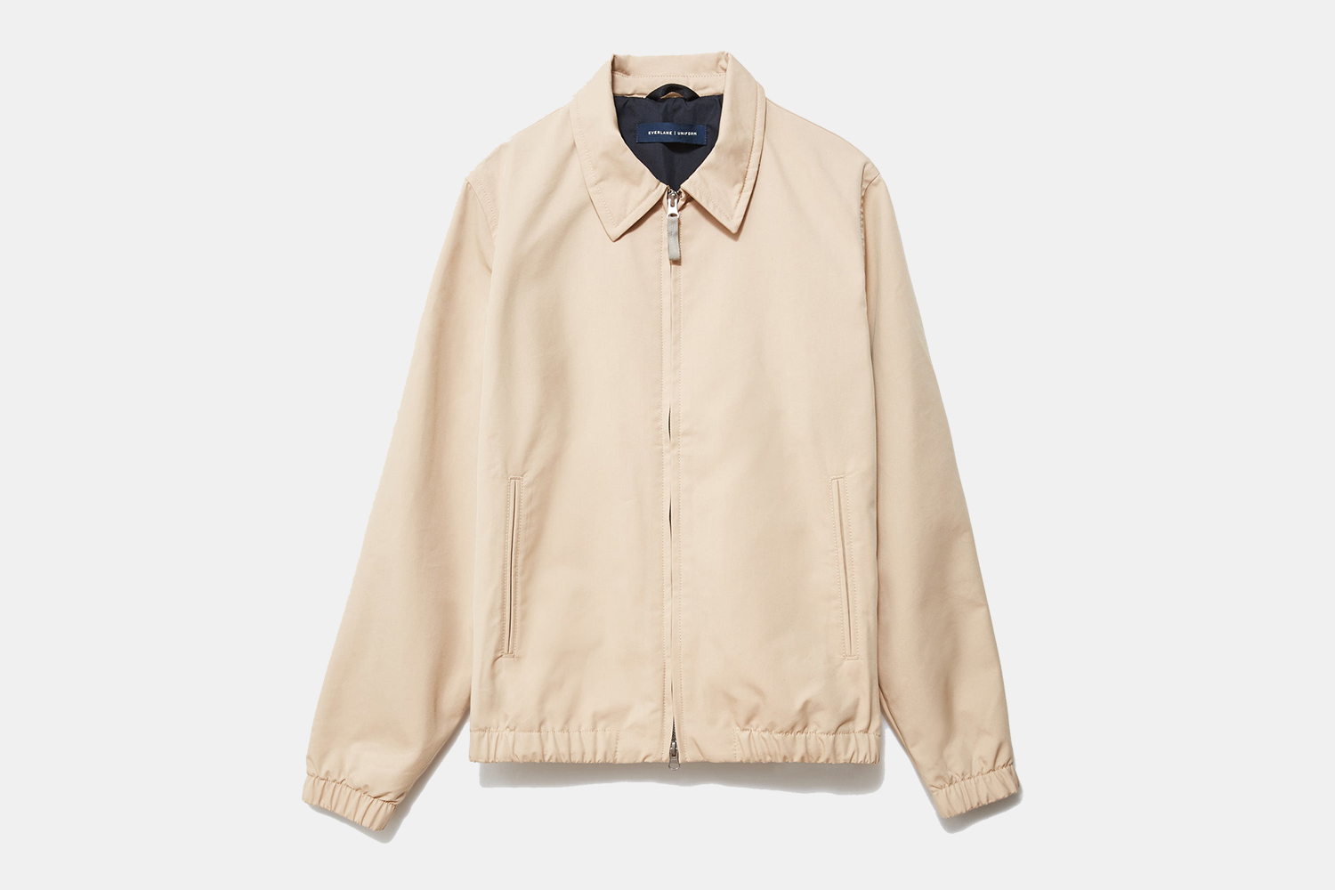 The Everyday Jacket from Everlane in khaki on a grey background