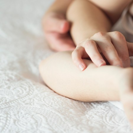 Couple lying in bed together holding hands