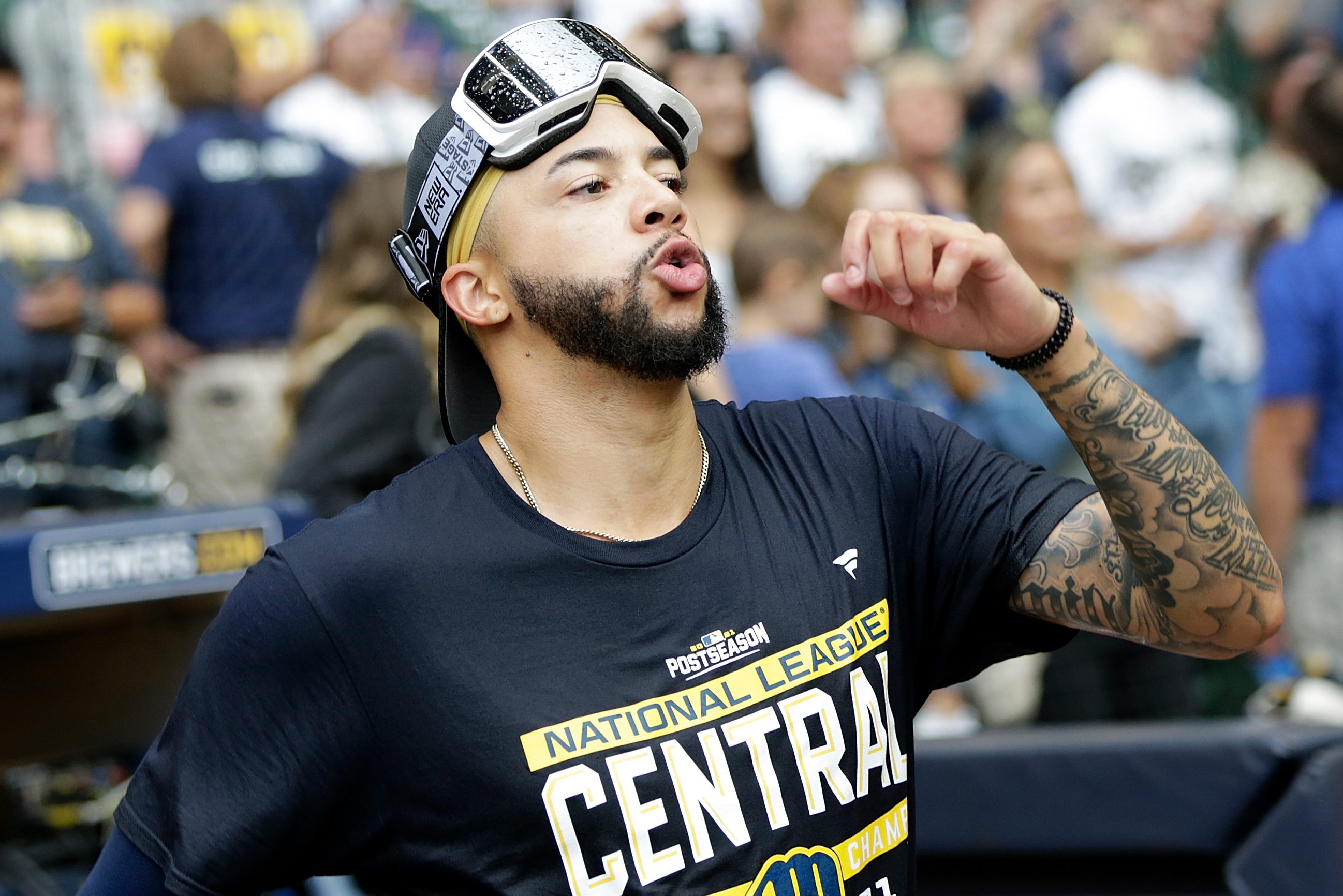 Devin Williams of the Milwaukee Brewers MLB team wearing goggles on his forehead and walking across the field, he had too much to drink while celebrating