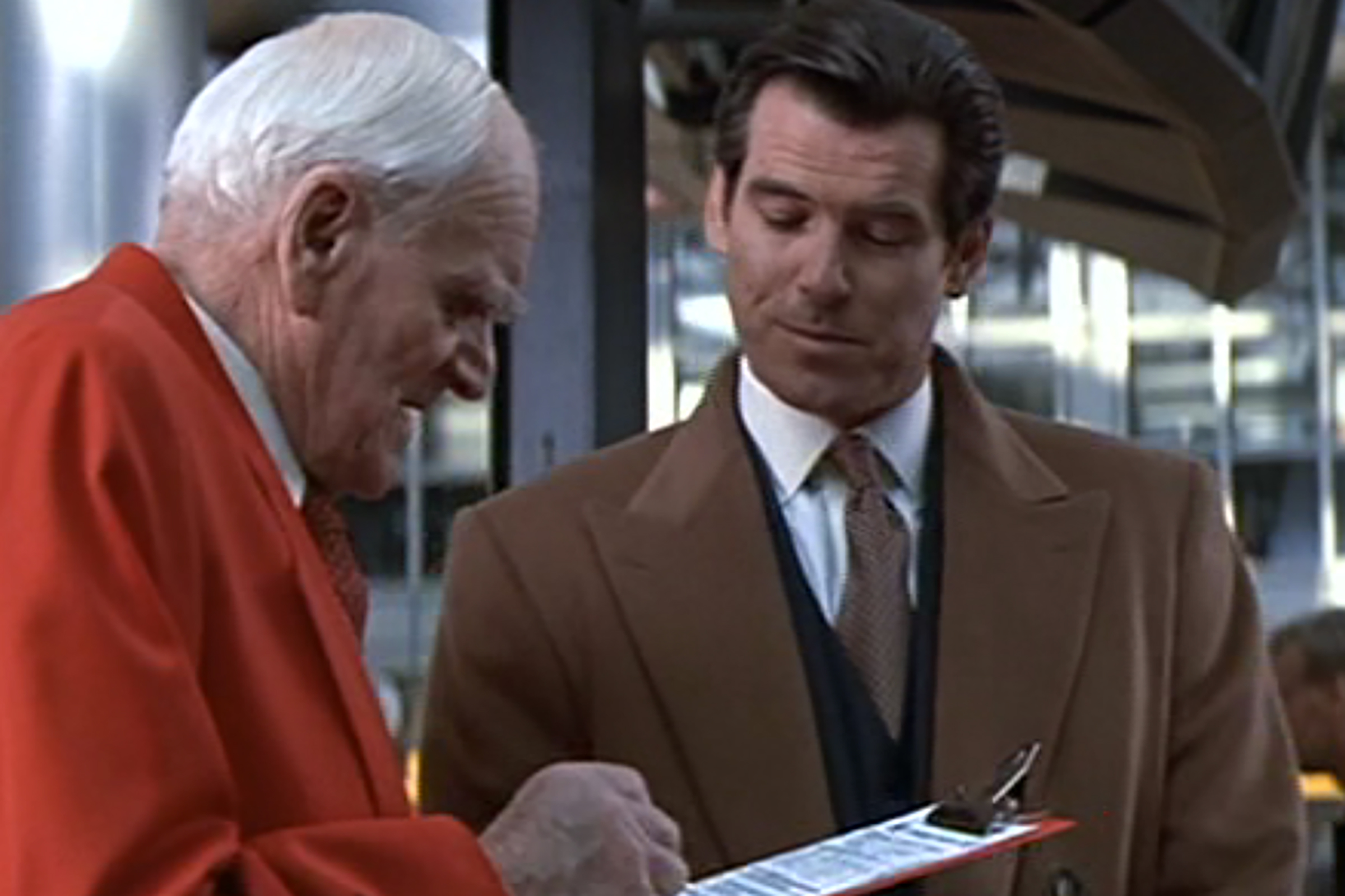 Brosnan wears a pristine Brioni navy suit in Tomorrow Never Dies.