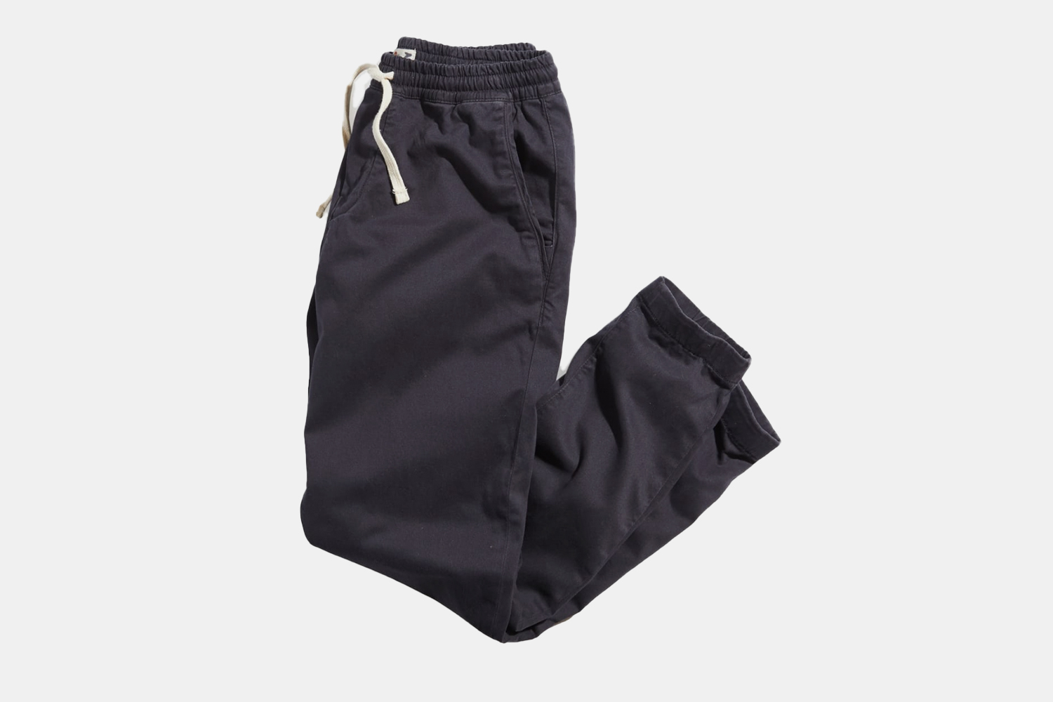 a pair of folded navy sweatpants