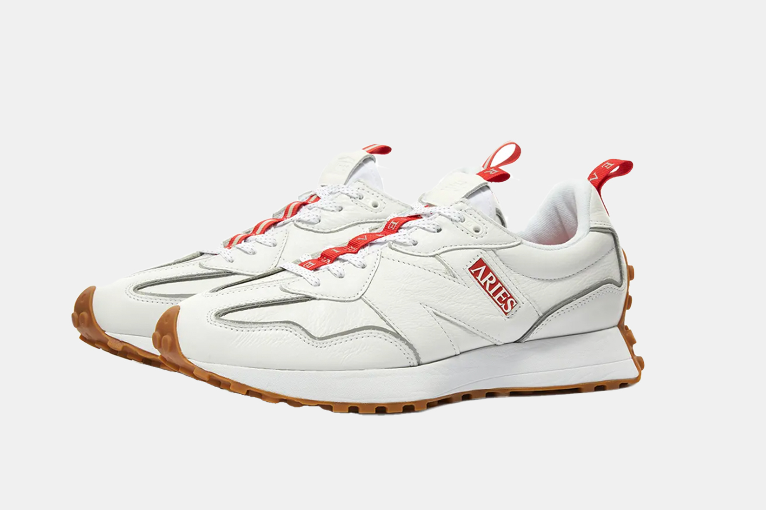 a pair of white, red accented sneakers
