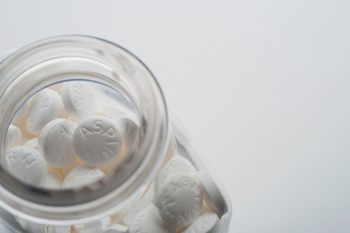 An open bottle of aspirin. A U.S. panel now recommends against most preventive use of aspirin against cardiovascular disease.