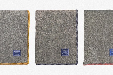 Three Bonfire Wool Throw Blankets from Faribault Woolen Mill, one with gold whip stitching, one with charcoal and one with red