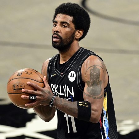 Kyrie Irving of the Brooklyn Nets handles the ball on the court against the Boston Celtics