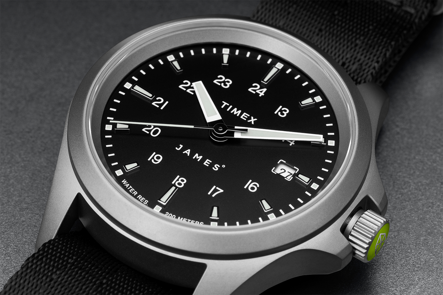 A close-up of the watch face on the new collab watch from The James Brand and Timex, featuring a 24-hour dial, Super-LumiNova and a titanium case