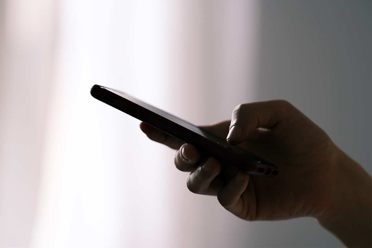A person holding their phone in one hand. Could they have smartphone pinkie?