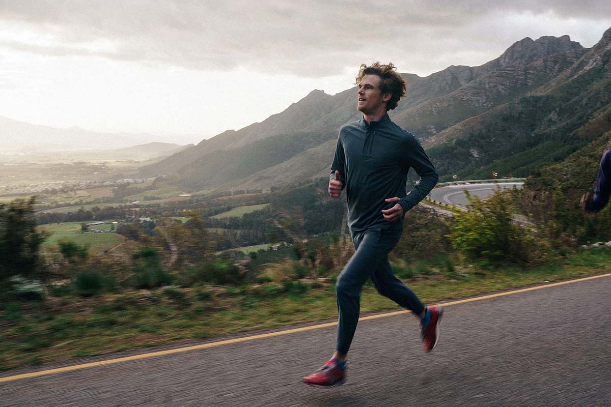 A man running in Janji track pants.