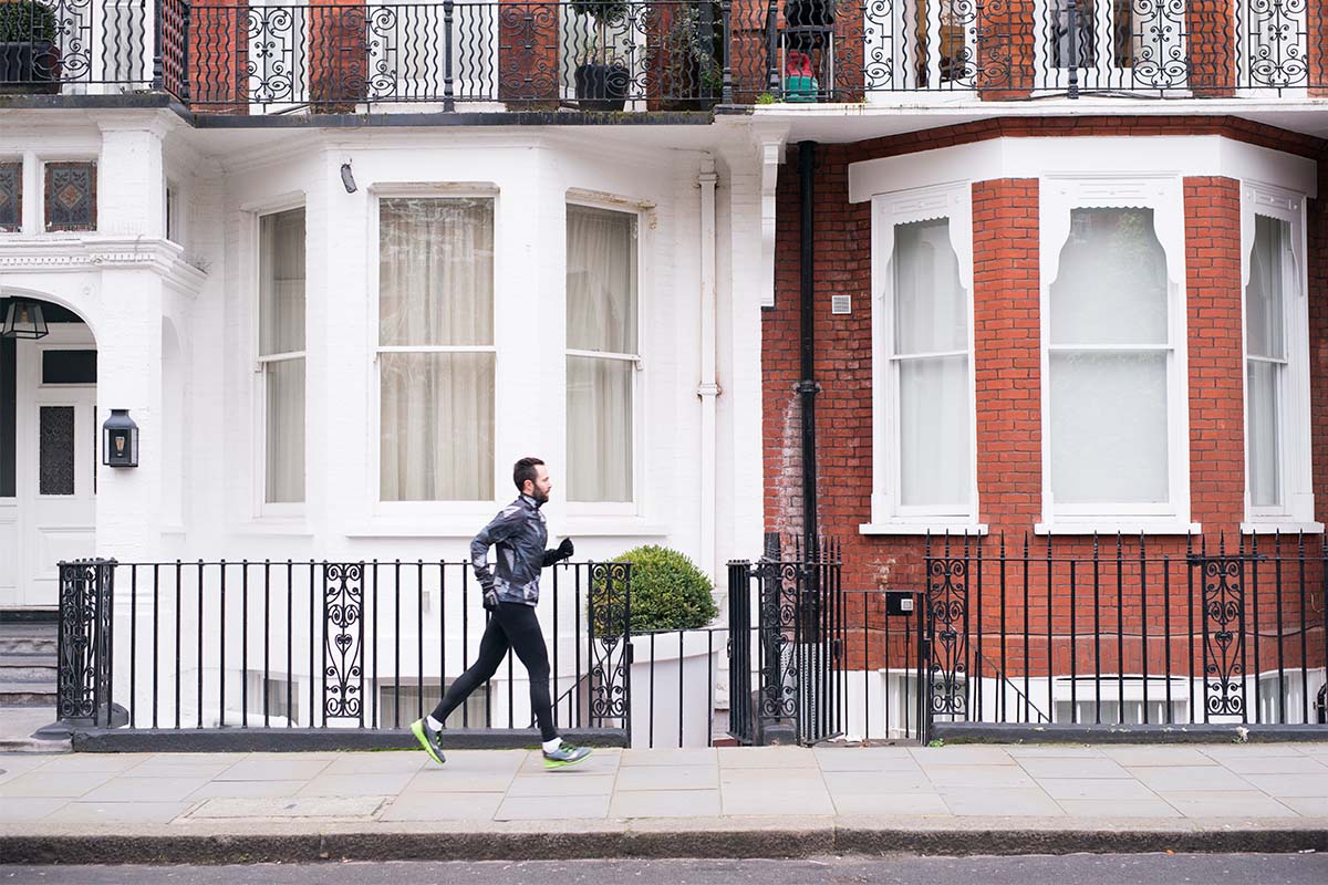 A man jogging down the sidewalk.