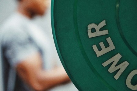 A man lifting weights at the gym.