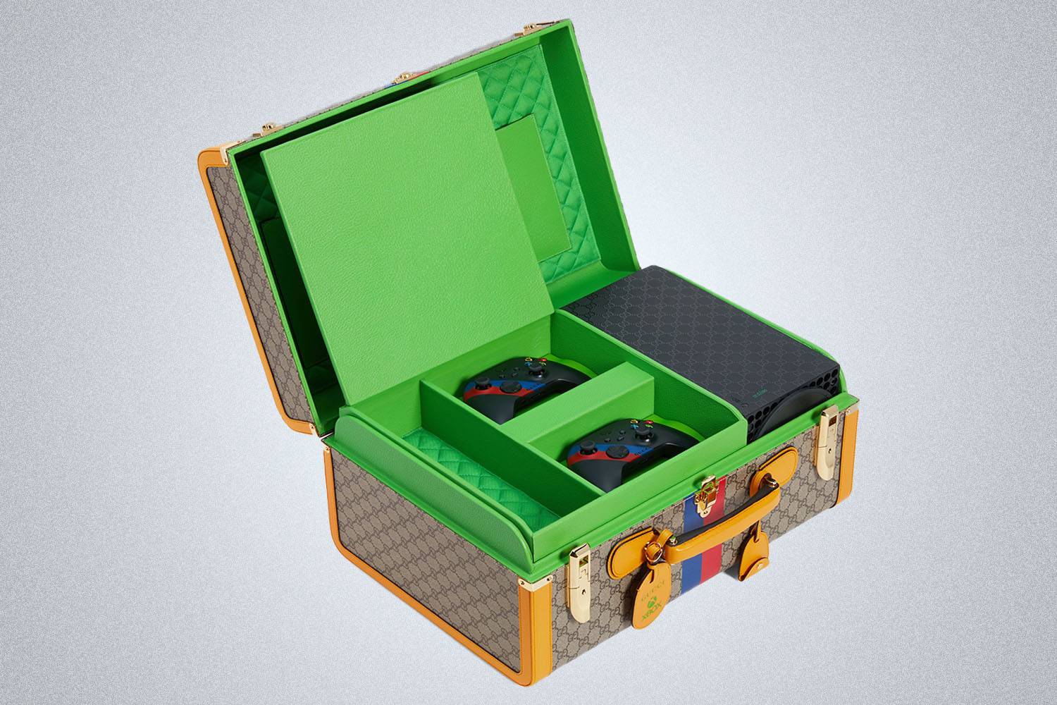 an xbox and controllers in a Gucci display case