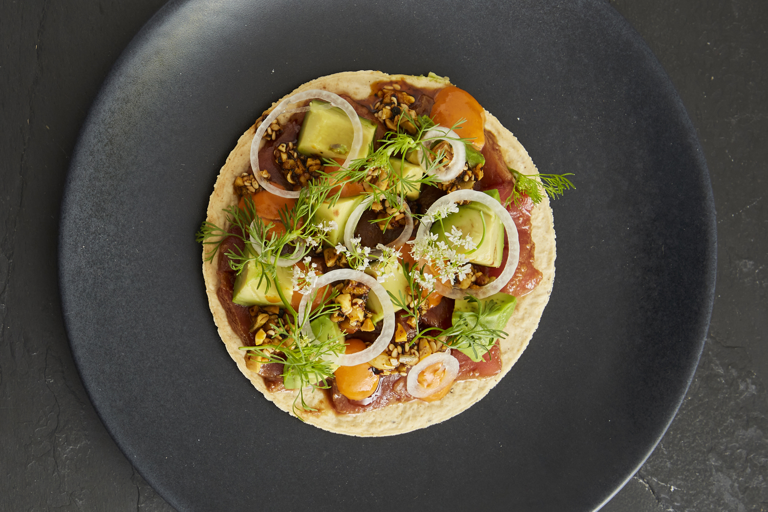 Tuna tostada with avocado, ponzu, ginger, cucumber, spicy mayo, salsa macha from Maïs64 restaurant in Washington, DC