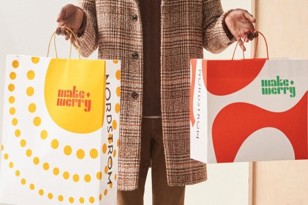 a man holding two shopping bags
