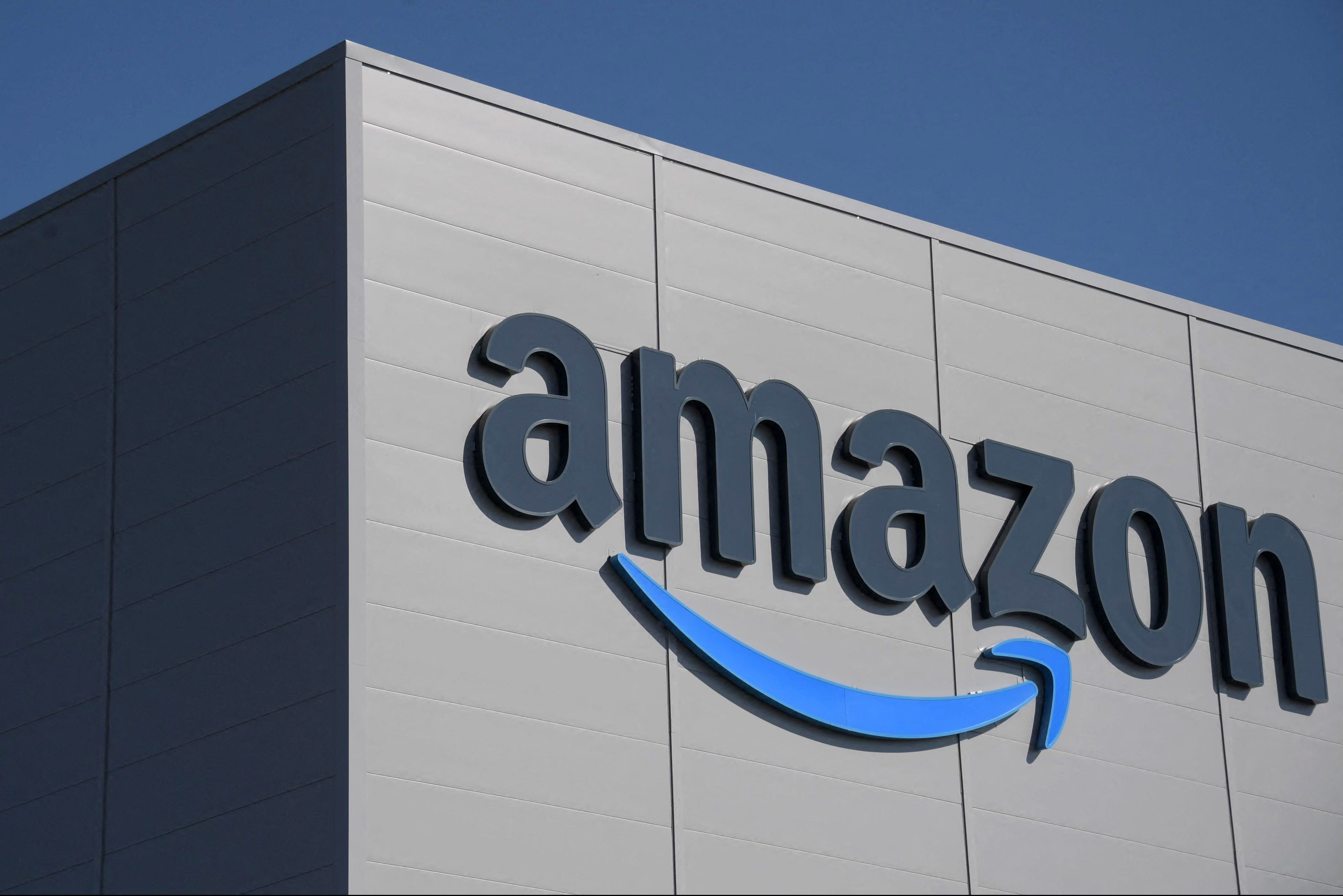 A giant Amazon logo on the side of a new distribution center in France