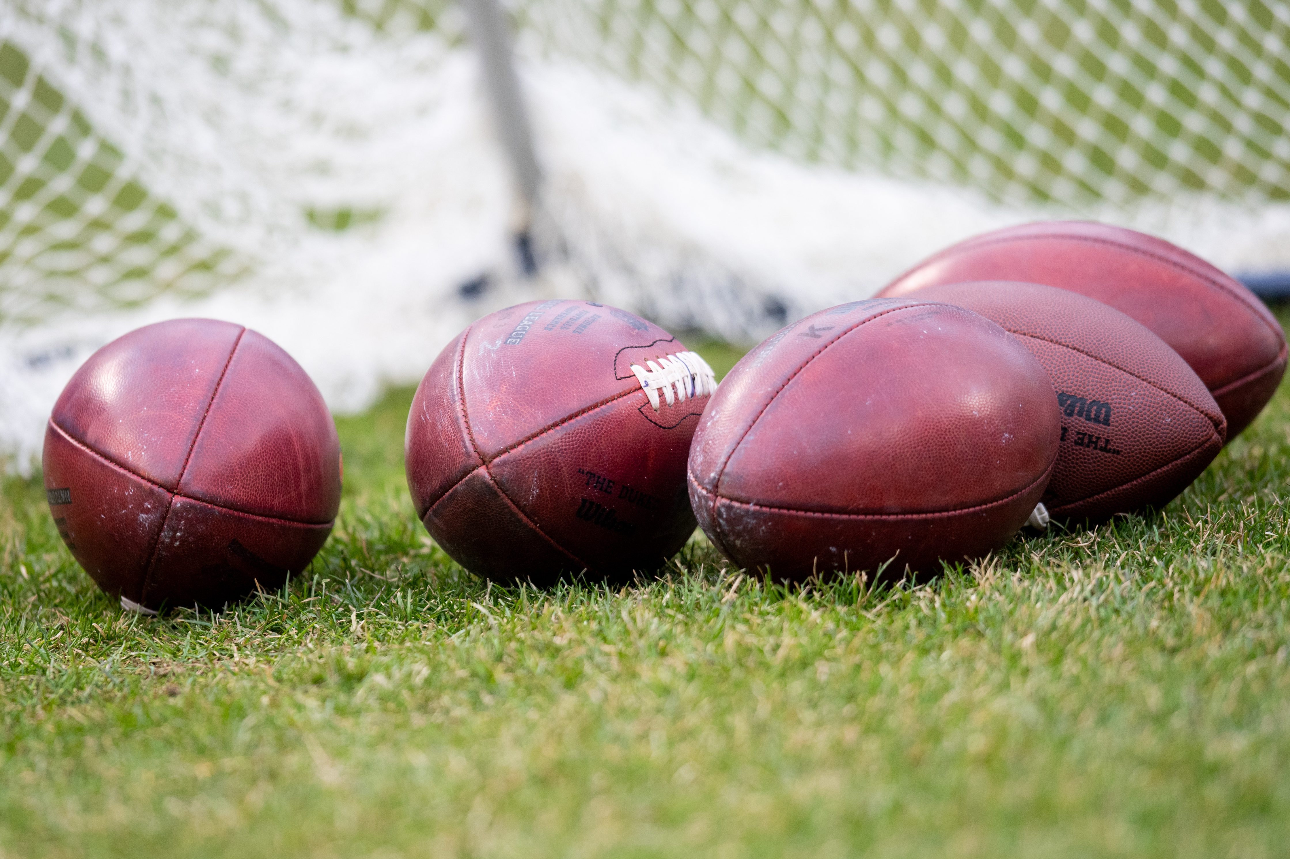 A stock view of footballs sitting on the field