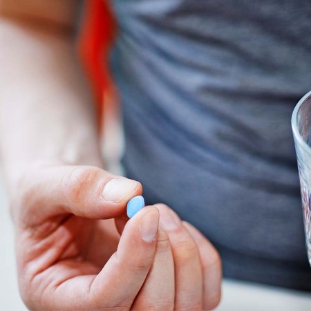 A man holding a Viagra pill.