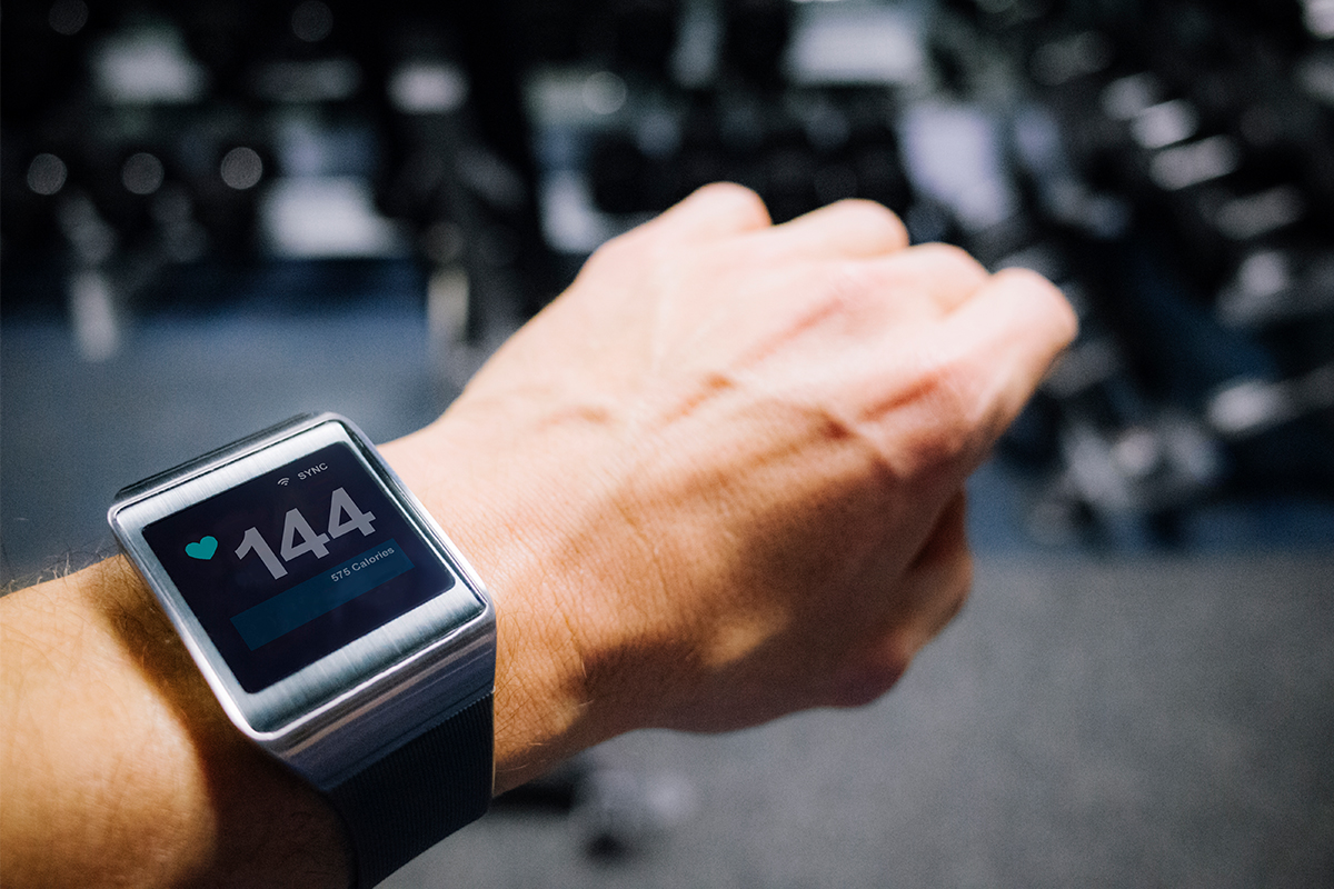 A close-up of fitness tracking watch that says "3.7 pounds left to lose."
