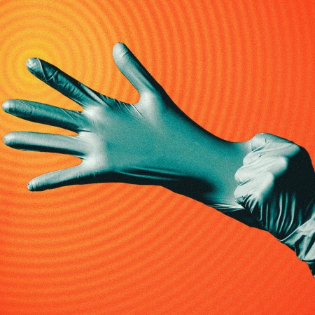 Image of a rubber glove being pulled over someone's hand