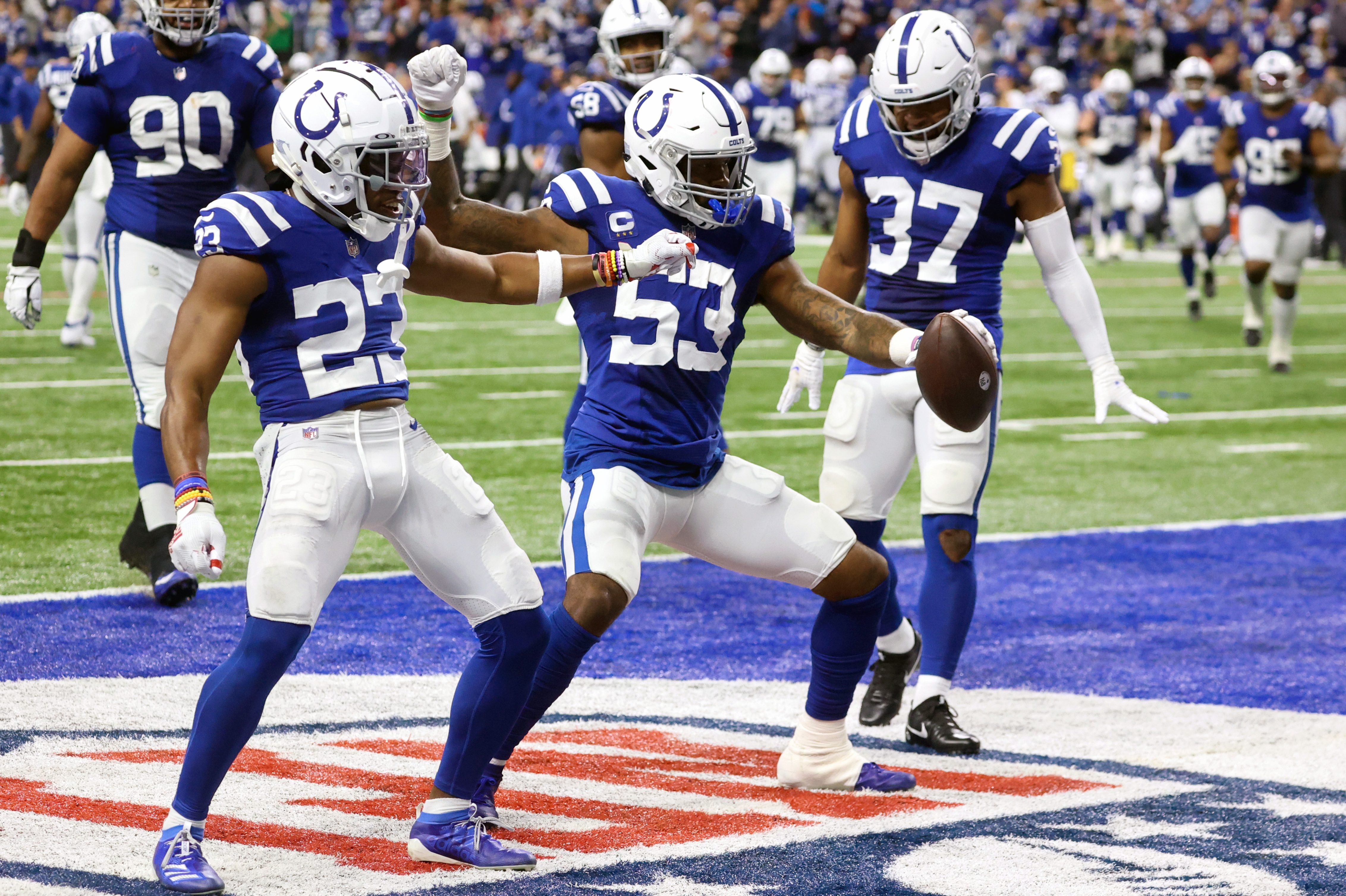Colts linebacker Darius Leonard and teammates celebrate his interception of a Mac Jones pass