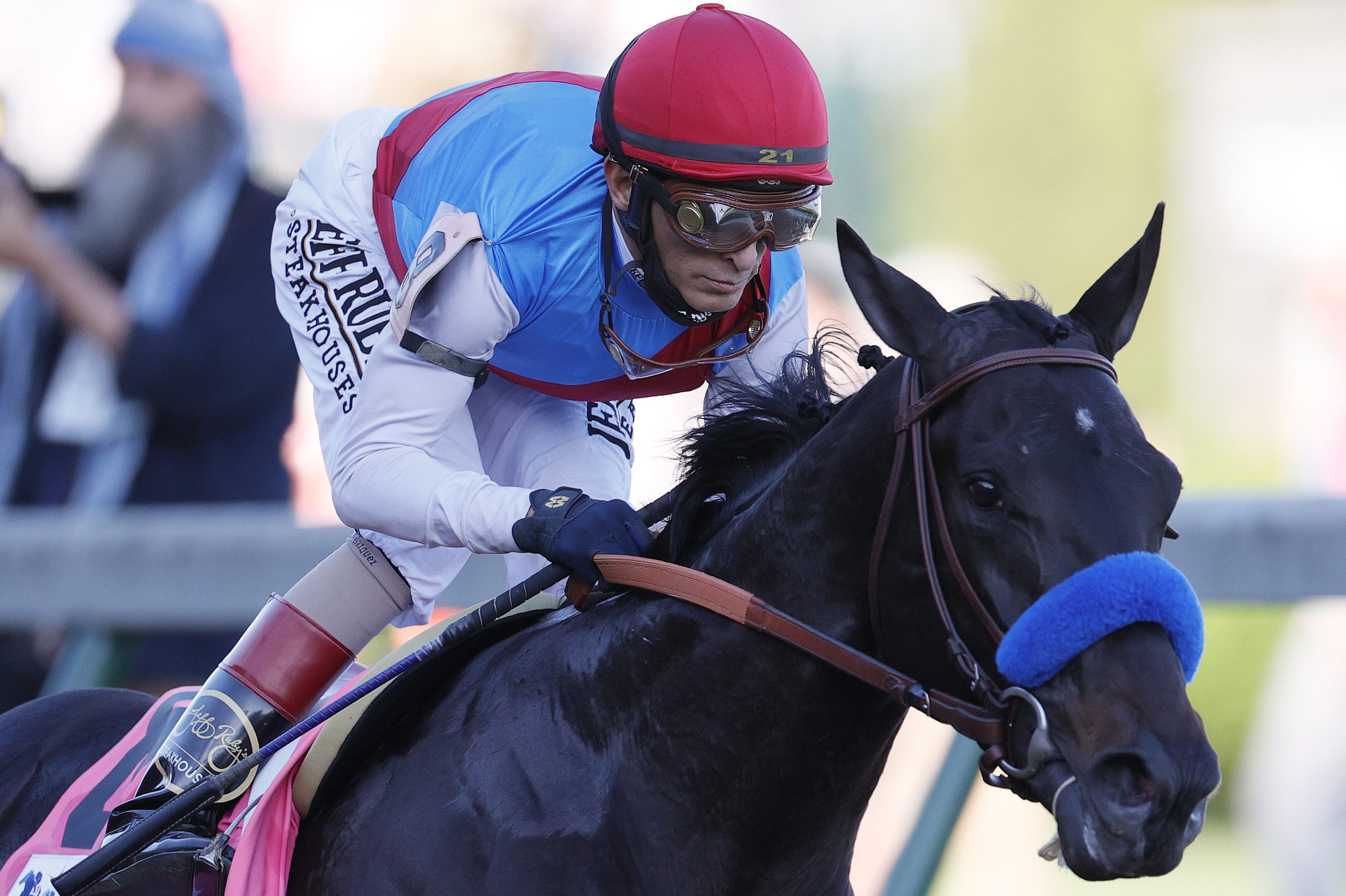 Medina Spirit leads the field at the first turn during the 147th Kentucky Derby