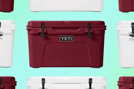 A grid of red and white Tundra hard coolers from Yeti on a green background. Yeti is offering free expedited shipping for guaranteed Christmas Eve delivery.