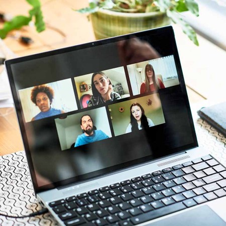 Close up of laptop participants on video conference, virtual team meeting, colleagues. Zoom just settled an $85 million class action lawsuit.