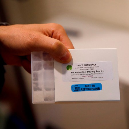 A man holding a small dosage of ketamine.