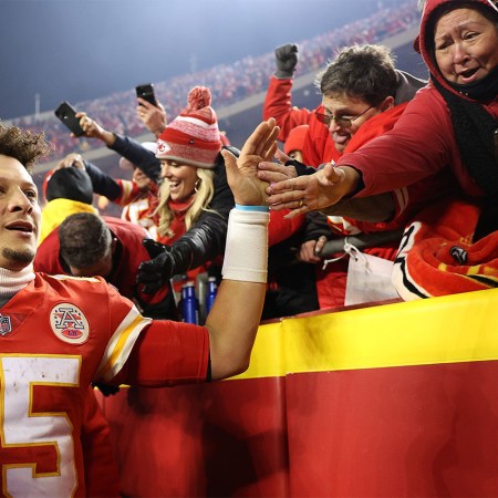 Kansas City Chiefs quarterback Patrick Mahomes high-fives fans. Fitness tracker WHOOP recently analyzed the star NFL player's heart rate from January 23, 2022 Bills vs Chiefs playoff game.