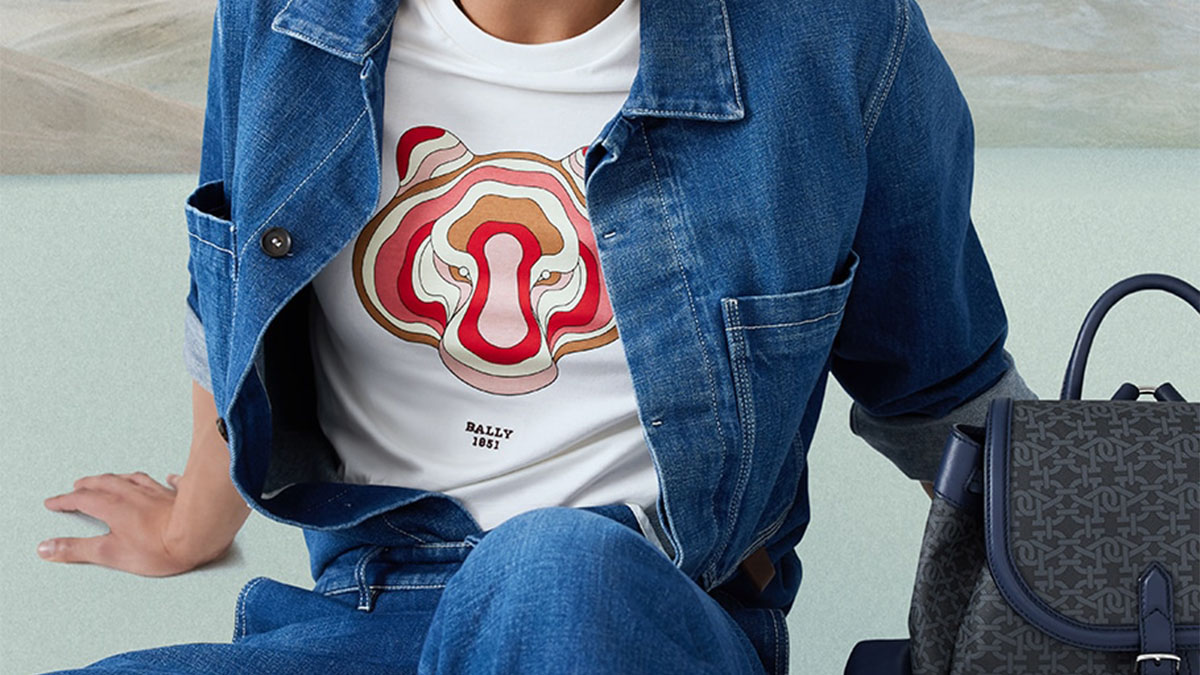 a shirt with a red colored tiger under a denim jacket and pants
