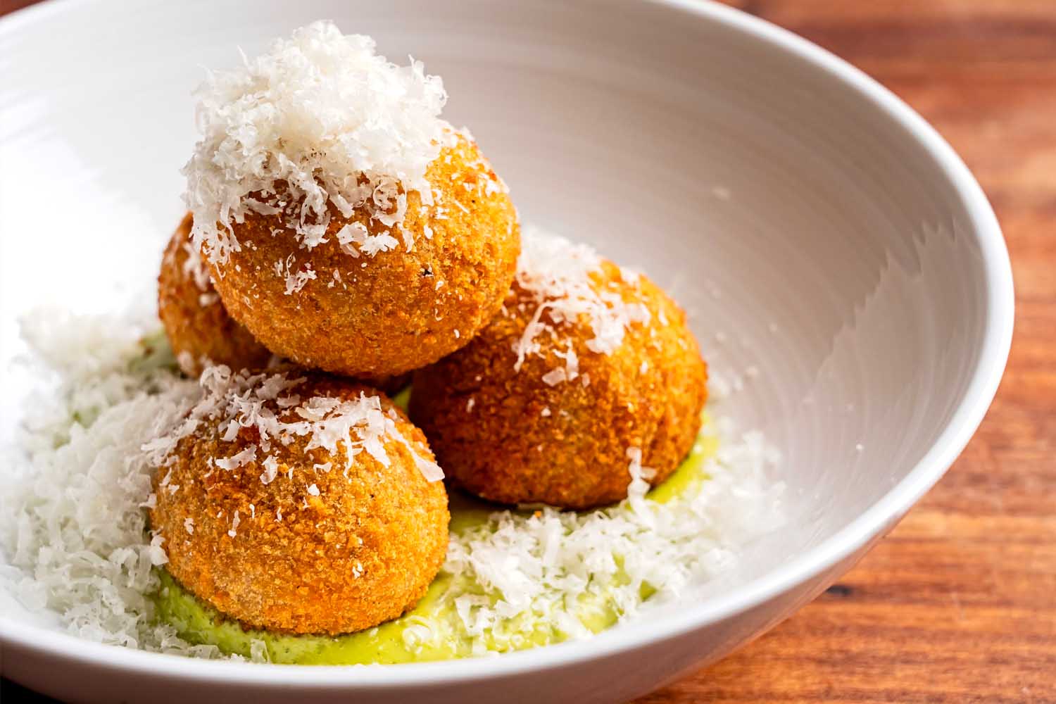 A bowl of Cacio e Pepe Arancini from DC restaurant The Red Hen.