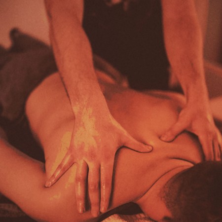 A man getting a massage, possibly a lymphatic draining massage.