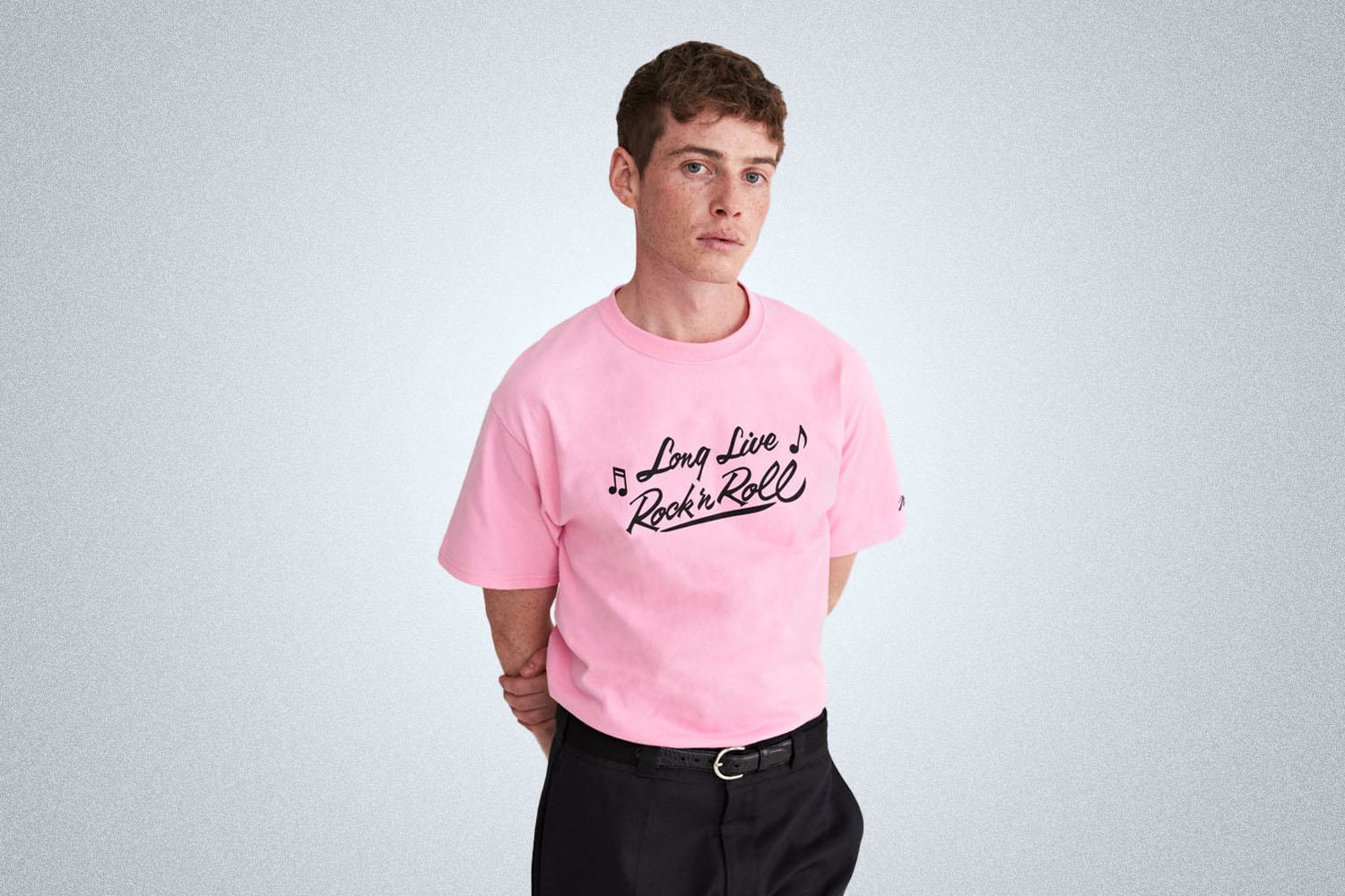 a model in. a pink graphic tee