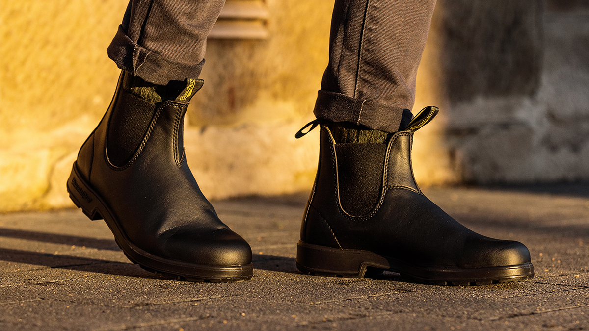 A man wearing Blundstone's #2115 Chelsea boots in black, the brand's first-ever vegan boots. We tested and reviewed them to see if they live up to the classic Blundstone #500.
